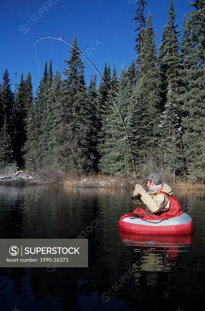 Flyfishing for trout from float-tube, Dennis lake, British Columbia, Canada