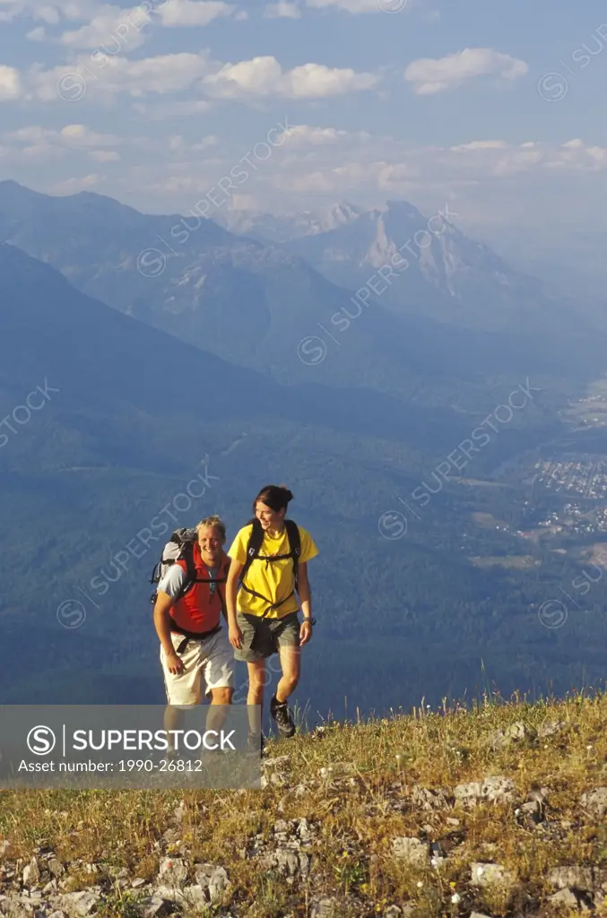 Young couple hiking at Fernie Alpine Resort near Fernie, British Columbia, Canada