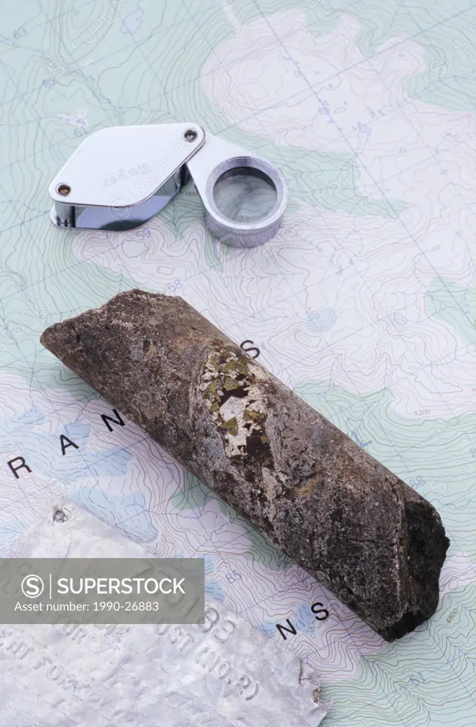 Mining exploration concept with, map, magnifier and core sample, British Columbia, Canada