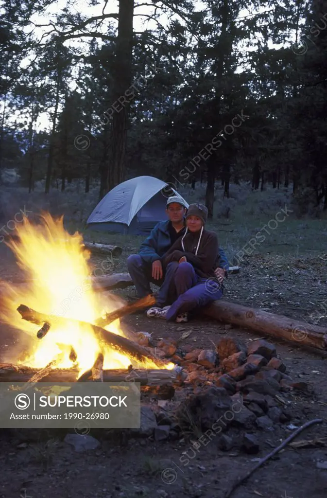 Couple enjoys fire while camping in the Dewdrop valley near Kamloops, British Columbia, Canada