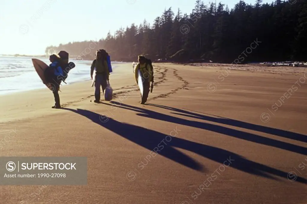 Canada, British Columbia, Hikers and surfers on remote beach West Coast, British Columbia, Canada