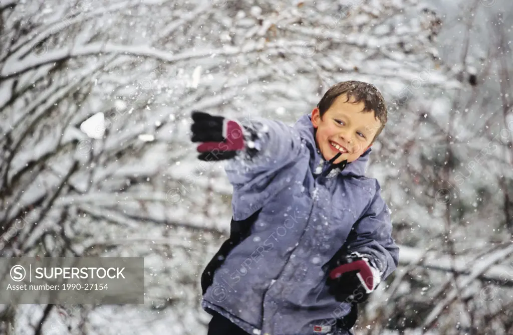 Boy throwing a snowball, British Columbia, Canada