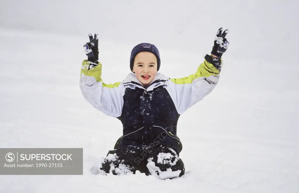 Boy playing in the snow, British Columbia, Canada