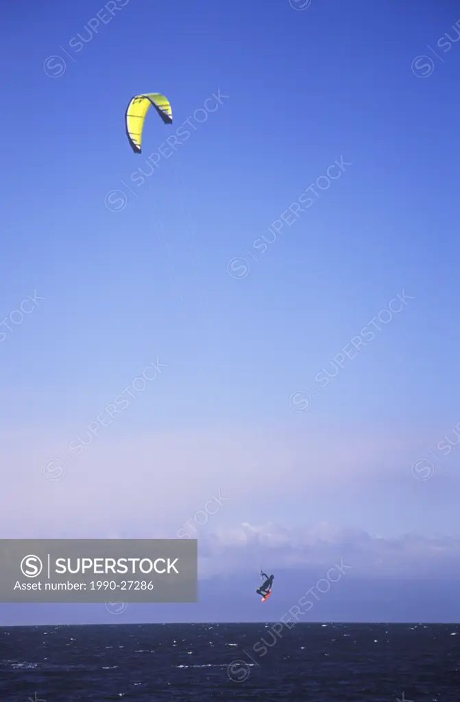 Woman kite boarder catching air at Clover Point Victoria, Vancouver Island, British Columbia, Canada
