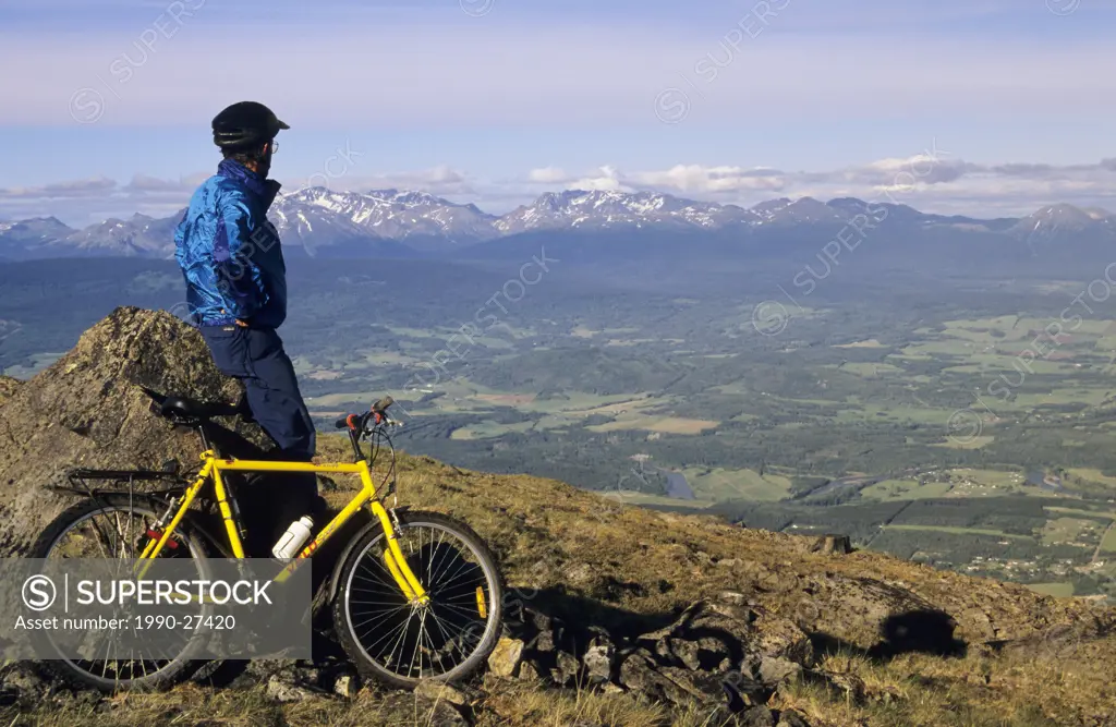 Mountan biker looking over Bulkley Valley, British Columbia, Canada