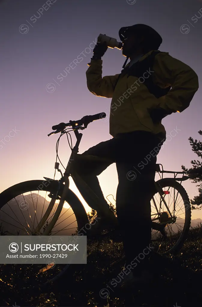 Mountain biker at sunset, Bulkley Valley, British Columbia, Canada