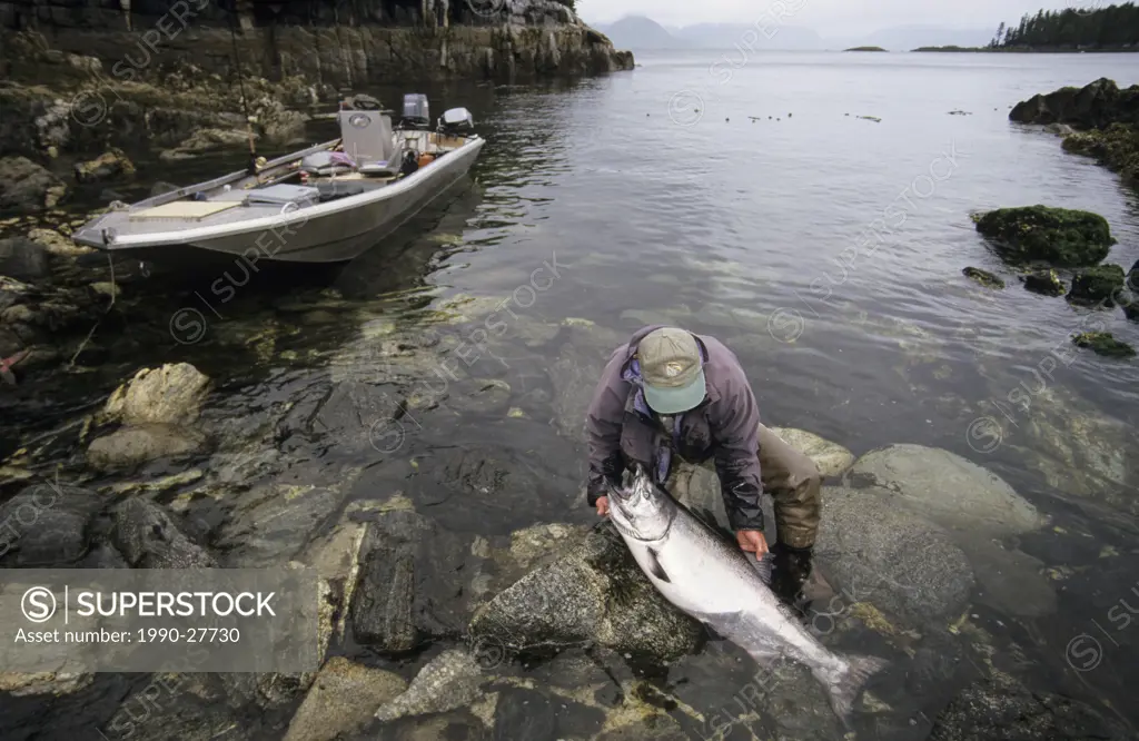 Angler cleaning chinook salmon, Work Channel, British Columbia, Canada