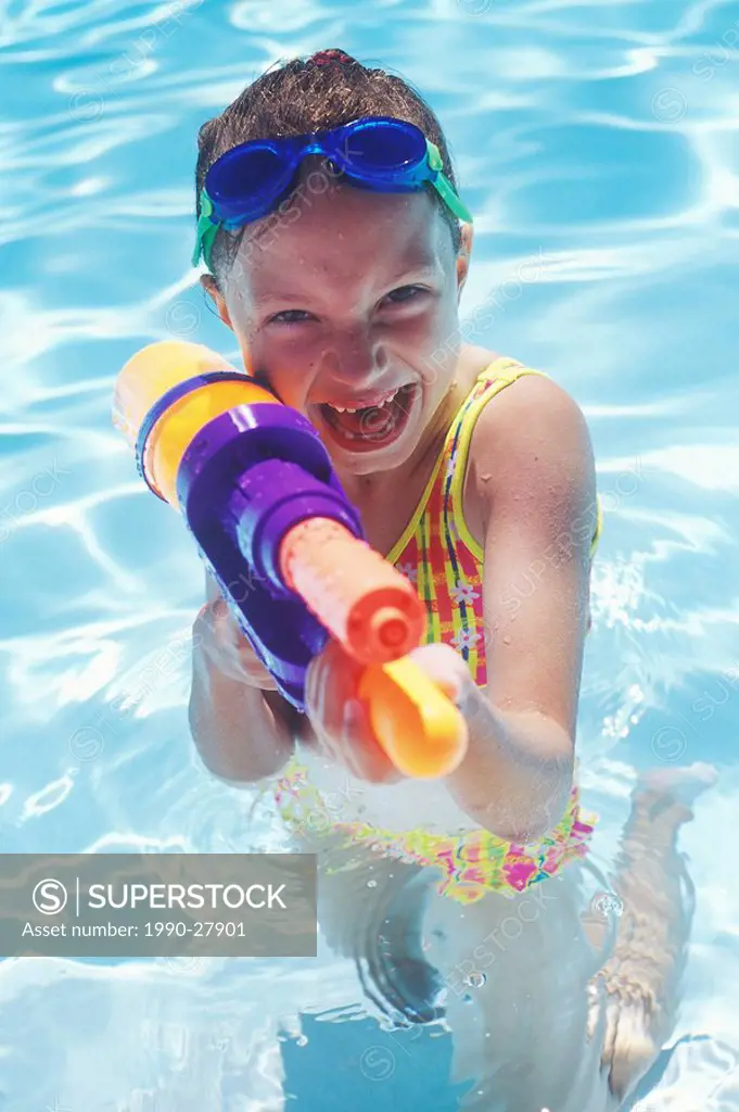 Girl playing in a swimming pool, British Columbia, Canada