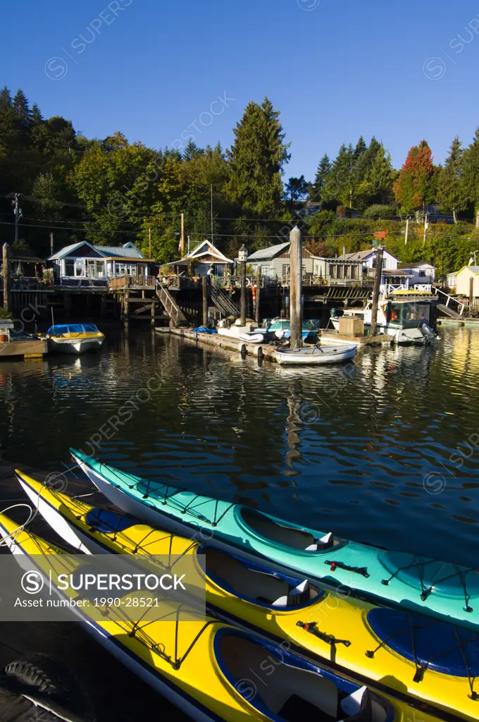 Kayaks on dock and watefront houses, Cowichan Bay, Vancouver Island, British Columbia, Canada