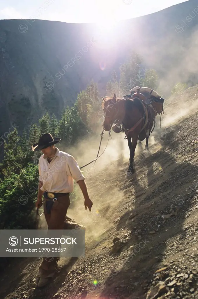 leading a horse in the South Chilcotin Mountains, near Gold Bridge, British Columbia, Canada