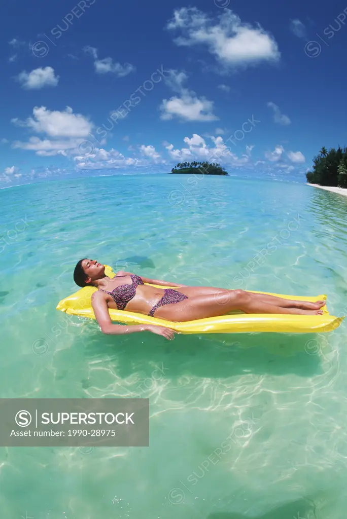 Cook Islands, South Pacific, Raratonga, Muri Lagoon, young woman on yellow float