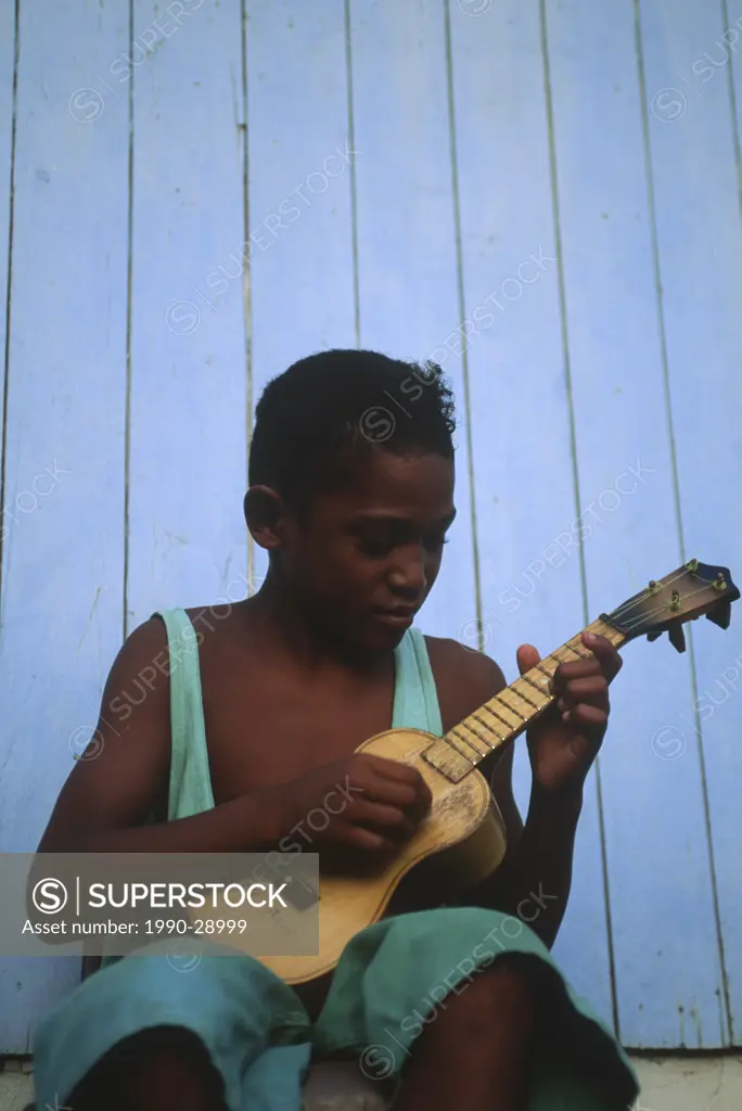 Cook Islands, South Pacific, Raratonga, local boy with ukeleli