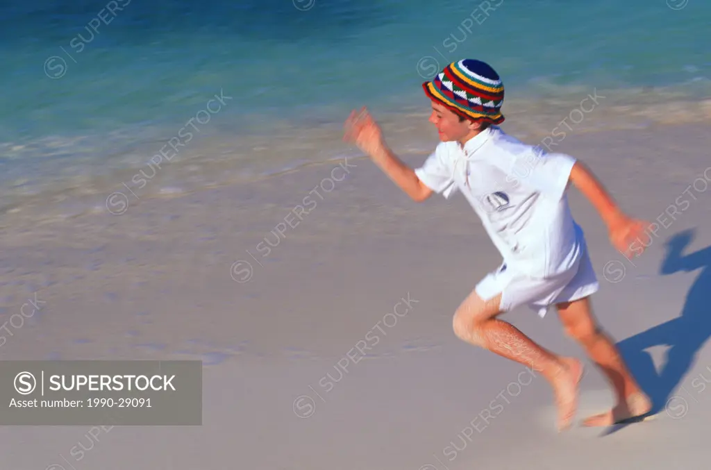 Mexico, Yucatan Peninsula, Carribean resort at Isla Mujeres, boy running on beach