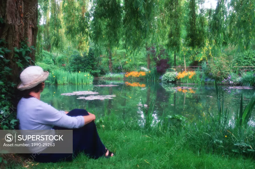 France, Giverney _ Monet´s Garden _ woman resting by pond