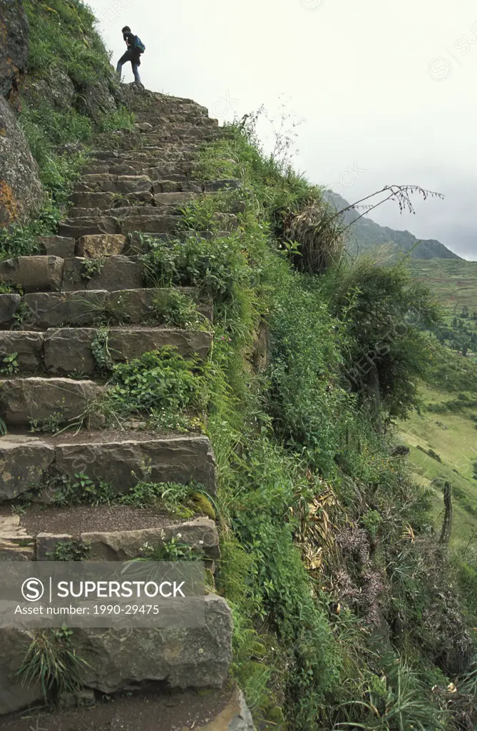 Traveller hiking in Machu Picchu UNESCO World Heritage Site, Urubamba Valley, Peru