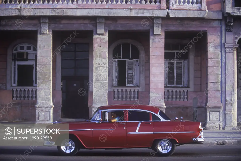 Classic car in front of old buildings on the Malecon at the edge of Barrio Chino, Havana, Cuba.
