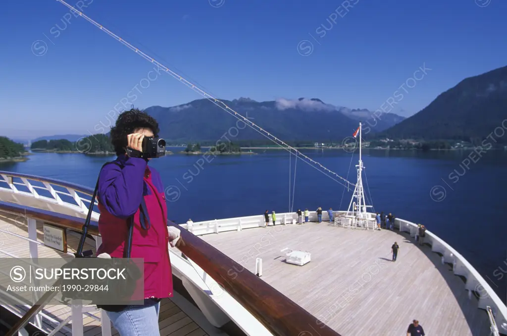 USA, Alaska, cruise ship bow heading to Sitka with woman shooting video