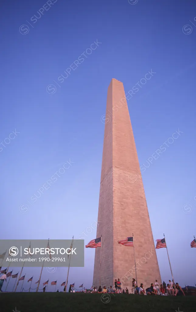 USA, Washington, DC _ Washington Monument with visitors under US Flags