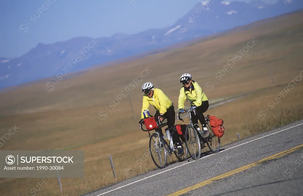 USA, Montana, couple cycling along the foothills near the rocky Mountains