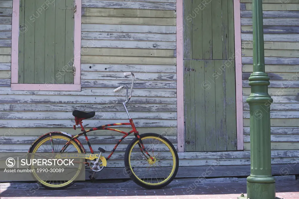 USA, Florida, Key West, cruising bike with custom paint leans on wall of old building