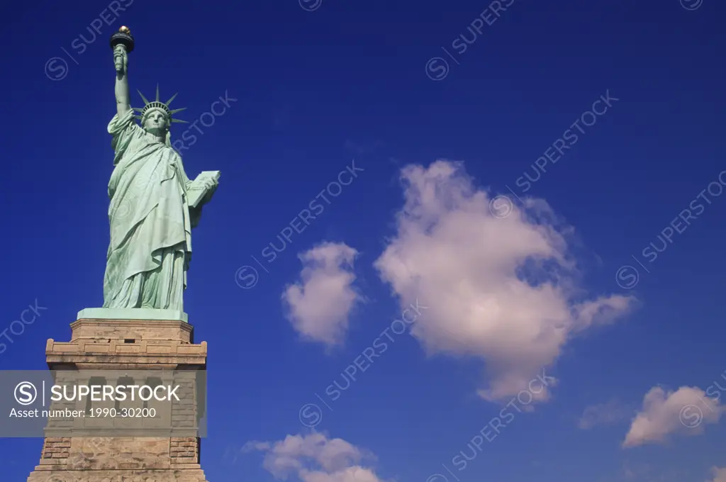 USA, New York City _ Statue of Liberty _ with cumulus clouds