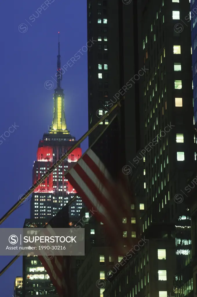 USA, New York City, Empire State Building , with flags at dusk