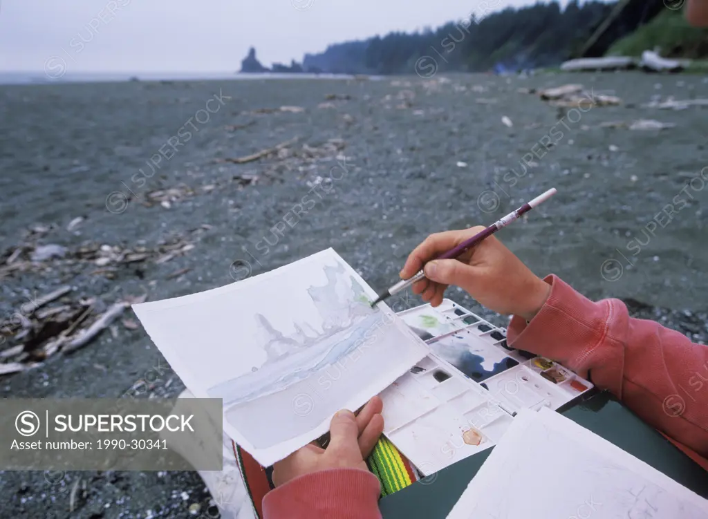 USA, Washington State, Olympic National Park _ Shi Shi Beach artists hands paint pinnacles