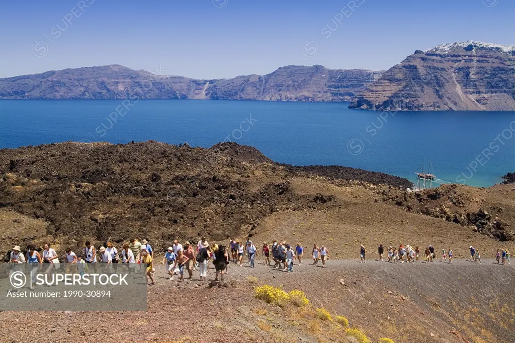 Tourists on Nea Kameni, the Active Island Volcano in the Caldera, Santorini, Cyclades Islands, Greece.