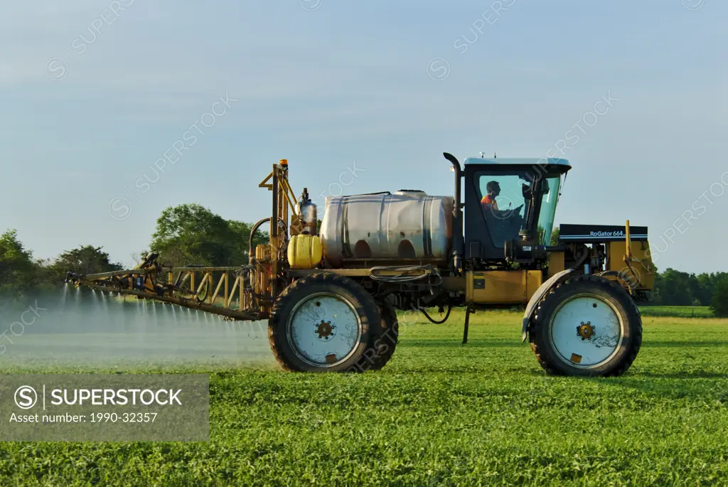 Crop Sprayer spraying herbicide on soy bean crop near Innisfil Ontario.