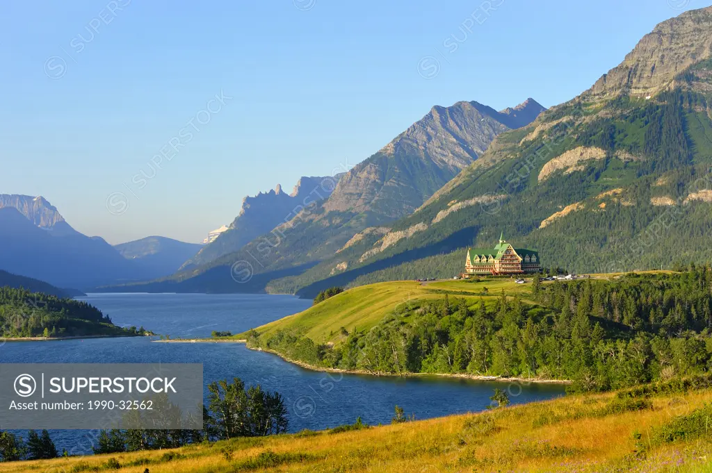 This summer landscape image of the mountains lake and Prince of Whales hotel was captured early one sunny morning in Waterton National Park Alberta Ca...