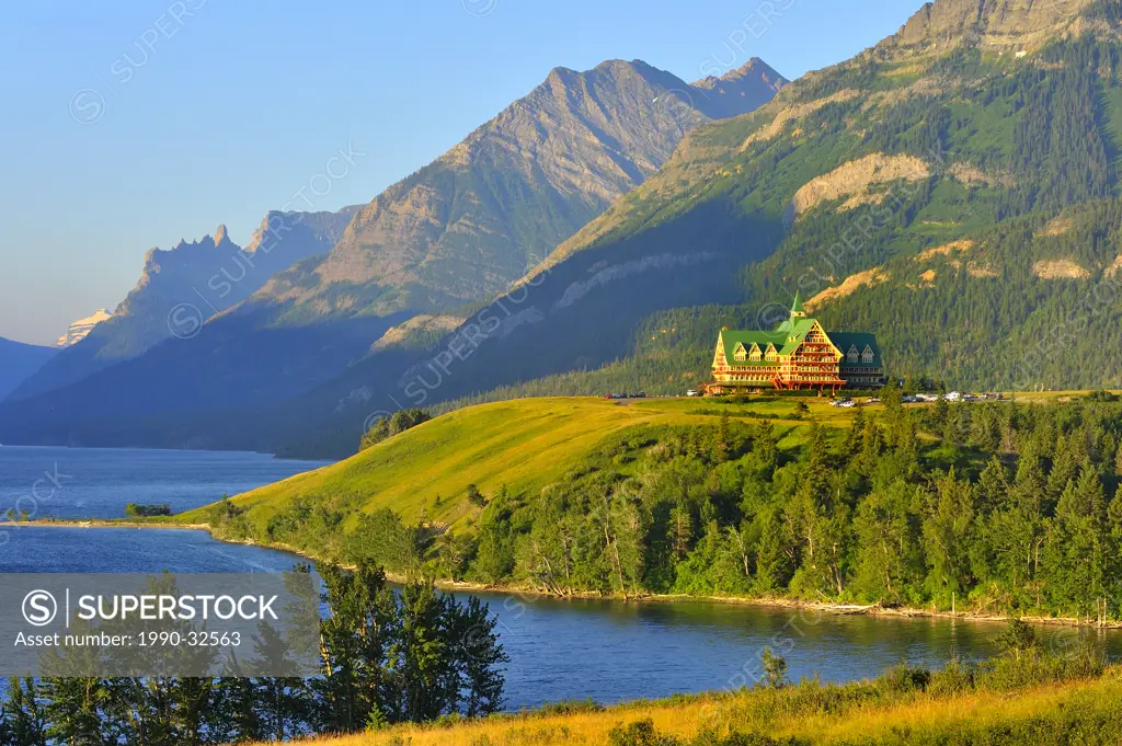 This summer landscape image of the mountains and Prince of Whales hotel was captured early one sunny morning in Waterton National Park Alberta Canada
