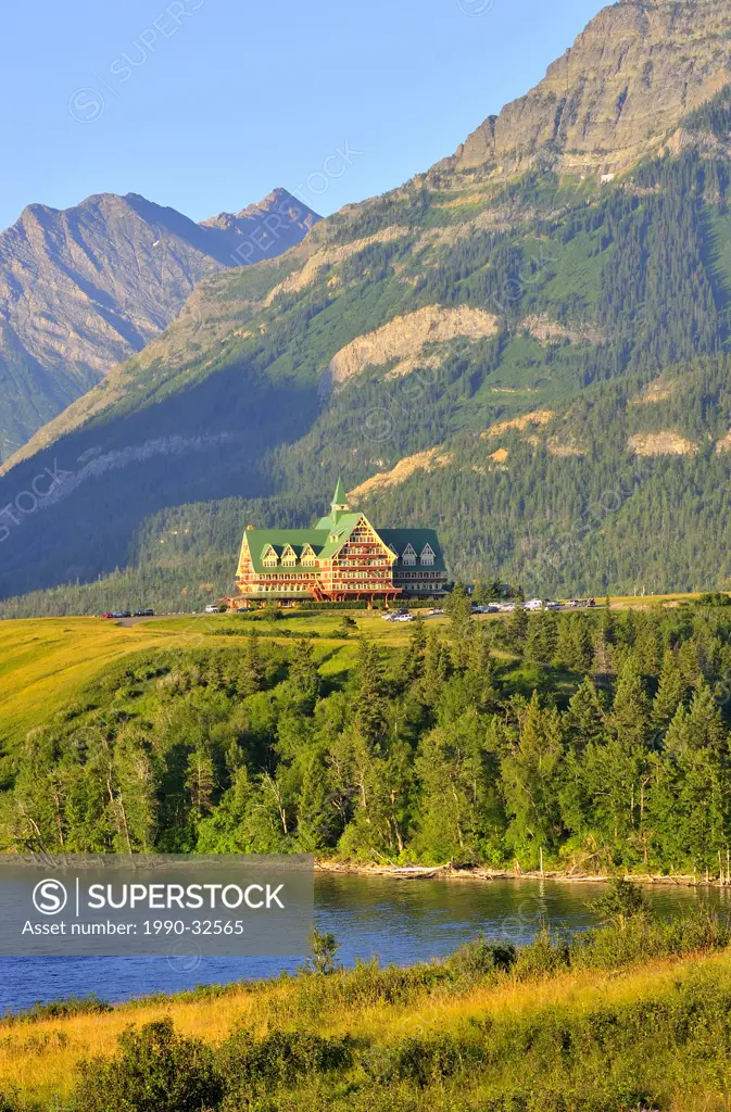 This vertical summer landscape image of the mountains and Prince of Whales hotel was captured early one sunny morning in Waterton National Park Albert...