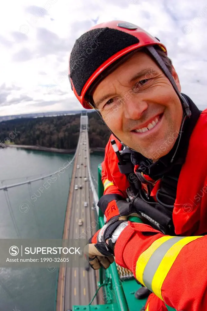 Emergency worker practises on supports of Lions Gate Bridge, Vancouver, BC , Canada