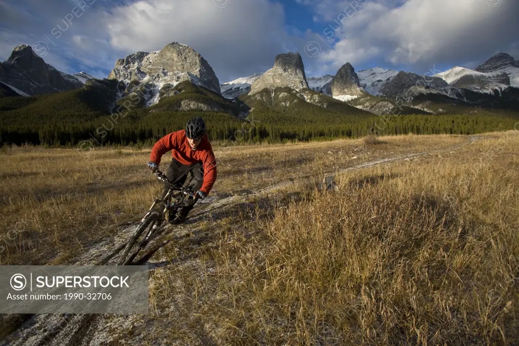 Male mountain biker enjoying the Canmore Nordic Center trails in the fall, Canmore, AB