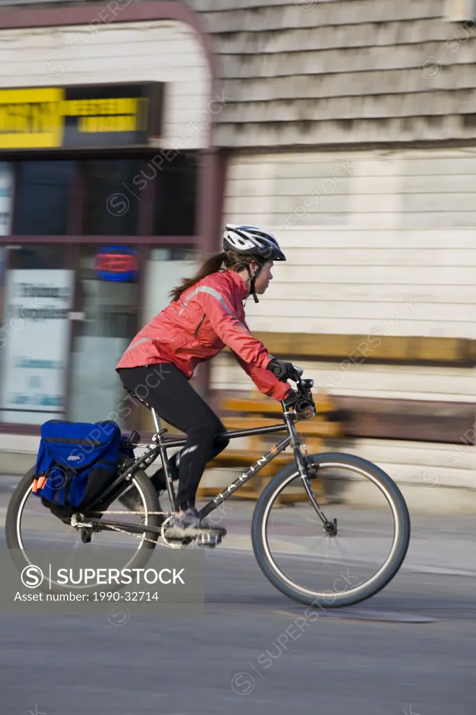 A young woman commuting on her bike in Canmore, AB