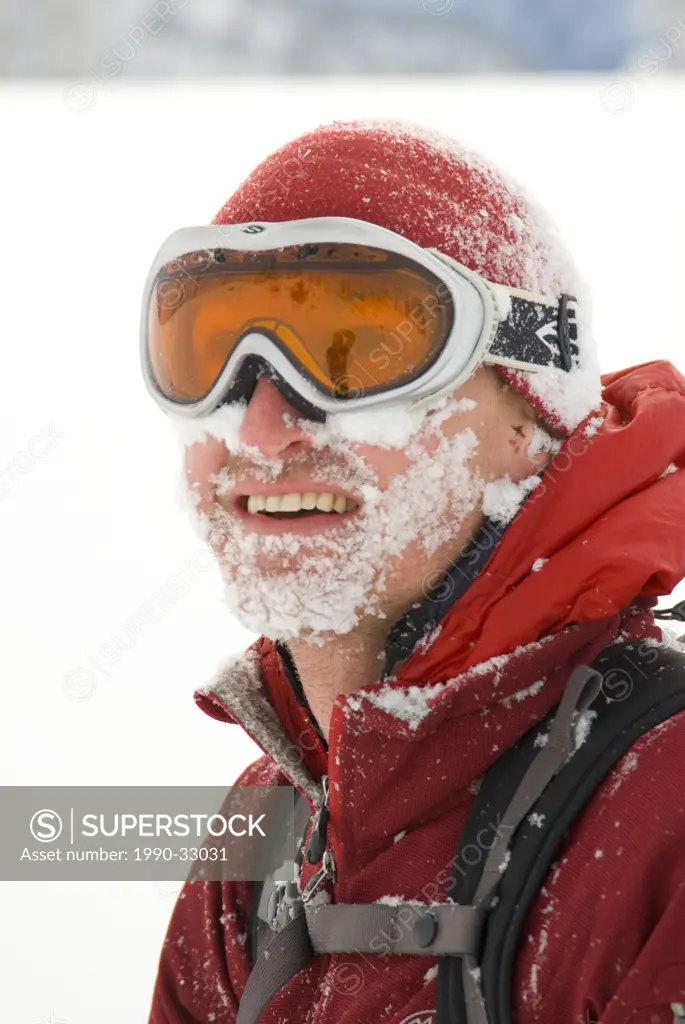 A male skier has a face full of snow, Monashee Mountains, British Columbia