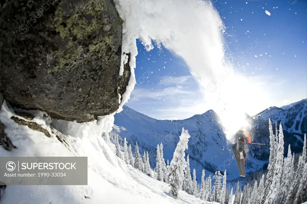 A male skier full of testosterone launches off a jump at Whitewater Winter Resort, Nelson, British Columbia