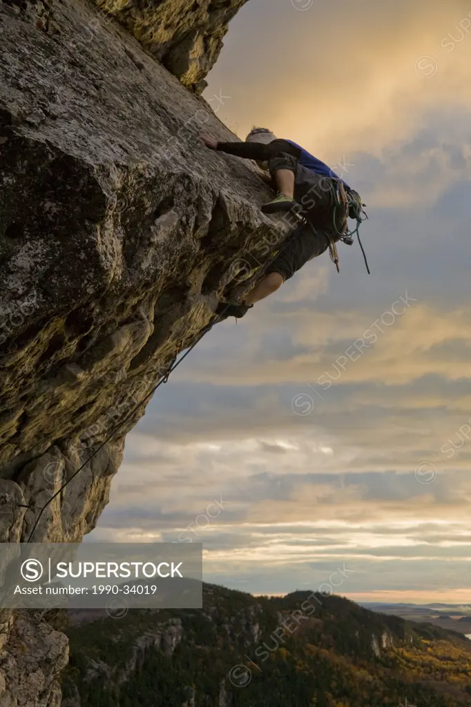 A young man climbs the popular route Moby Dick 5.11b, Kamouraska, QC