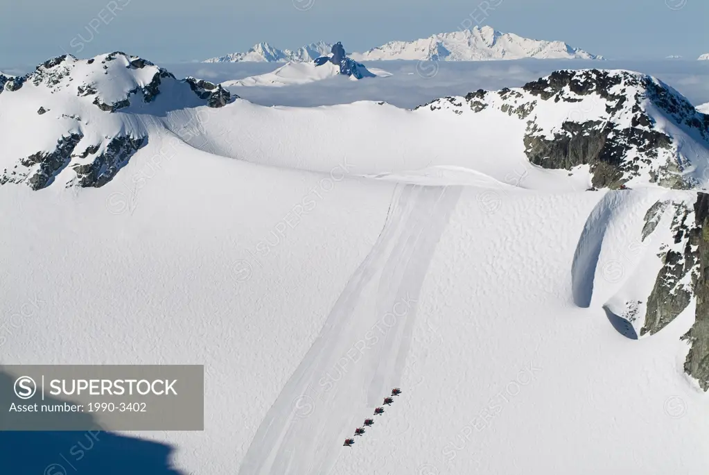 aerial of snow cats on blackcomb glacier with black tusk and tantalus range in background, british columbia, Canada