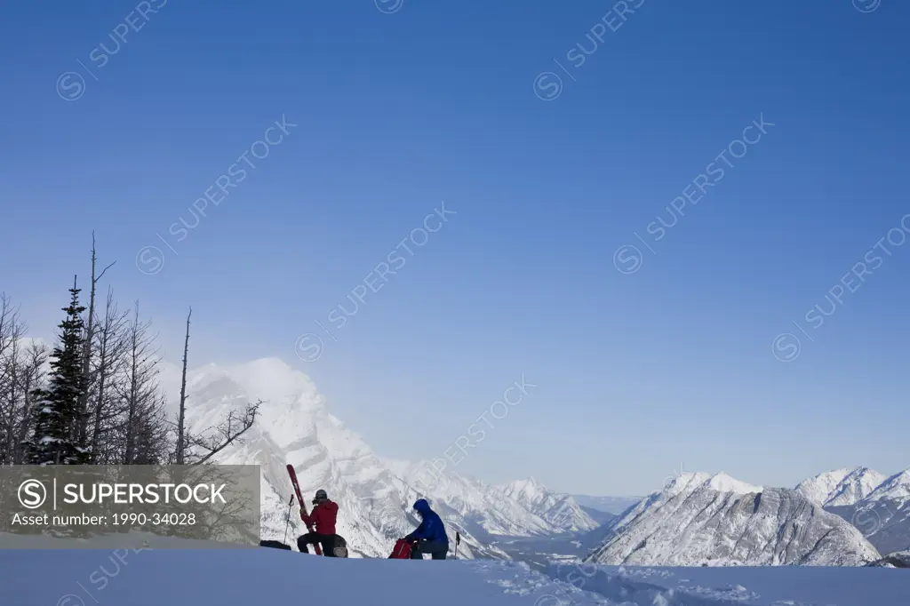 Two men prepare to desend while ski touring in, Kananaskis, AB