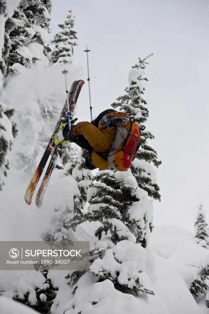 A young man doing a front flip in the Revelstoke Backcountry, BC