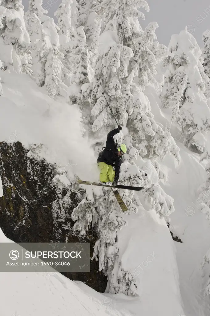 A male freeskier airing a cliff in the Revelstoke Resort Backcountry, BC