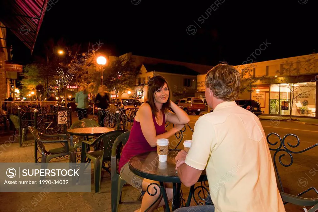 A young couple stop for a drink at a coffee house, while enjoying an early evening shopping trip in downtown Kamloops, in the Thompson Okanagan region...