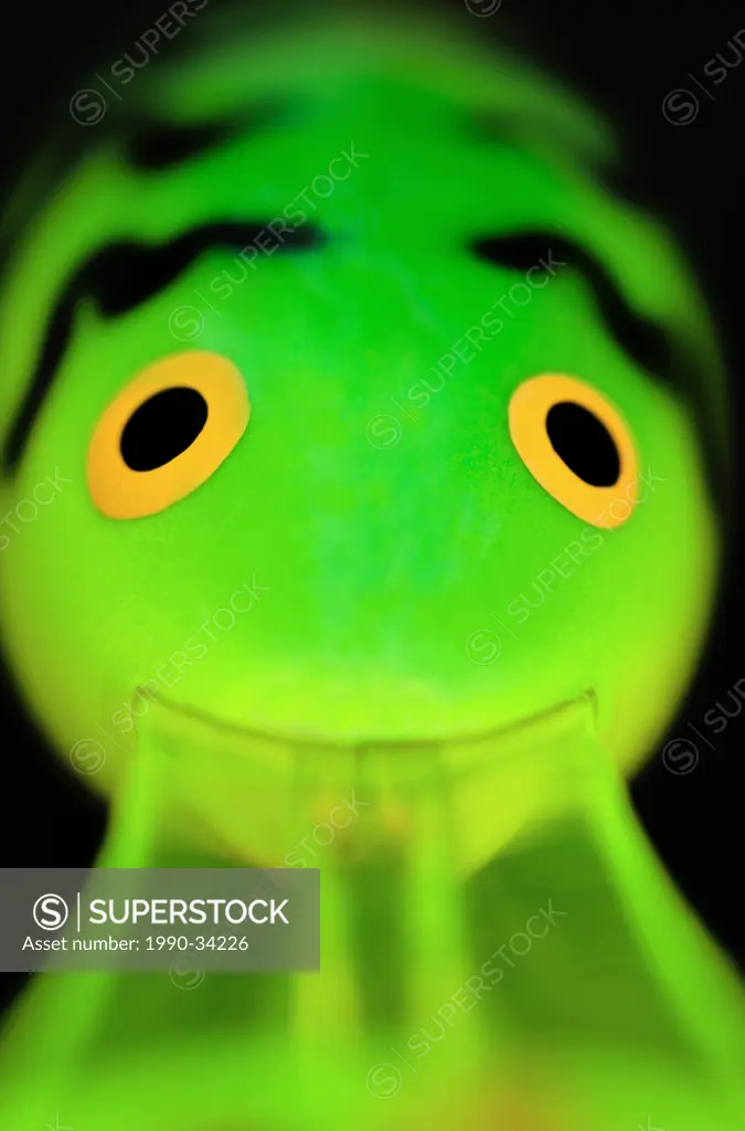 Close_up of a chartreuse fishing lure with bright eyes.