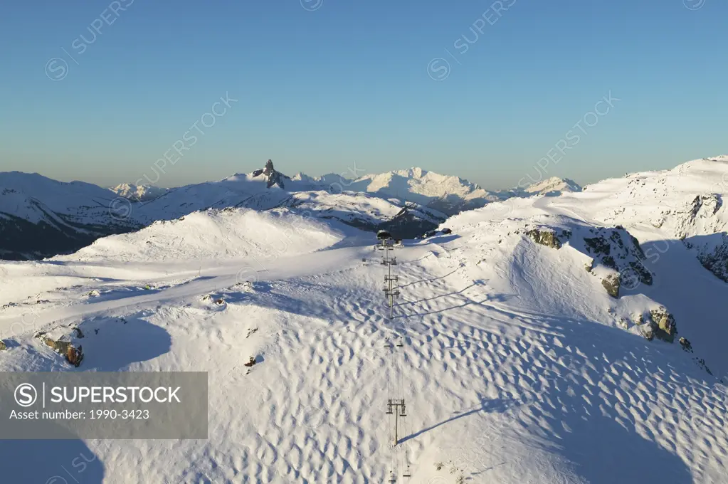 aerial of harmony express chairlift with black tusk and tantalus range in background, british columbia, Canada