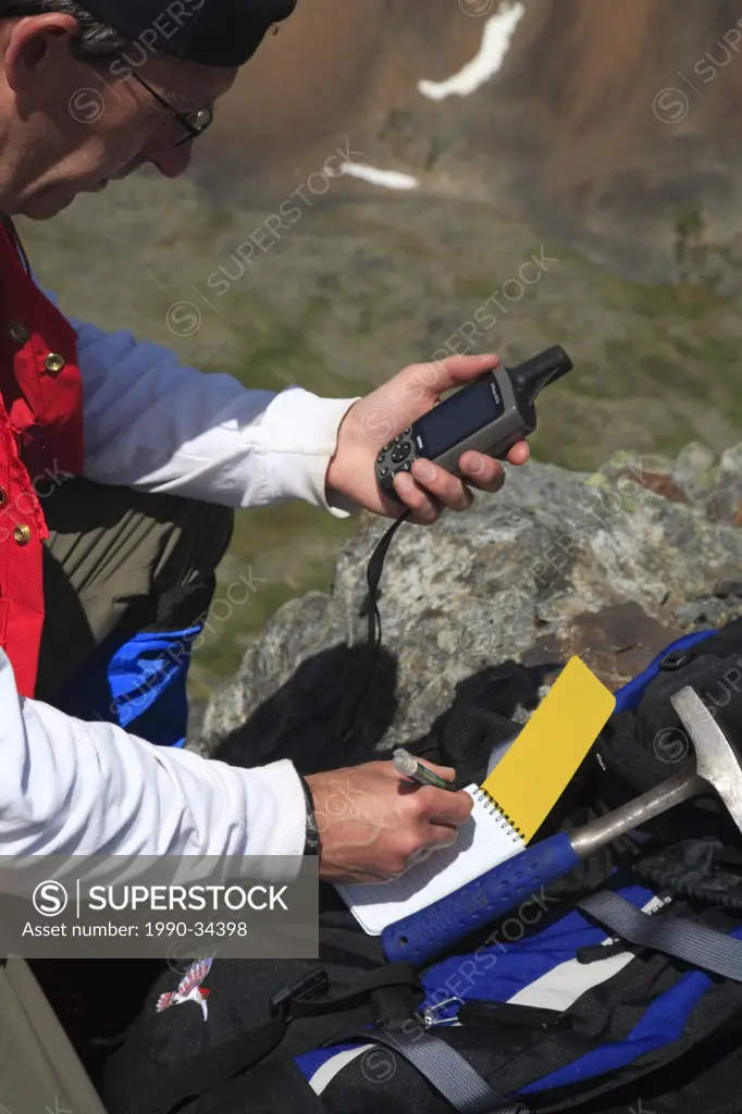Geologist doing mining exploration fieldwork with GPS, Hudson Bay Mountain, Smithers, British Columbia