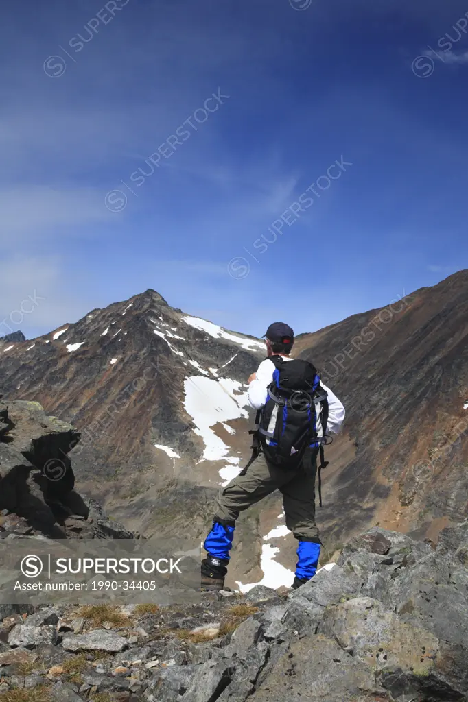 Hiker in rocky alpine, Hudson Bay Mountain, Smithers, British Columbia