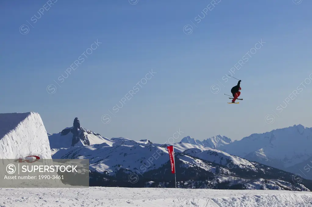 Aerial competetion on whistler mountain with black tusk and the tantalus range in the background, british columbia, Canada