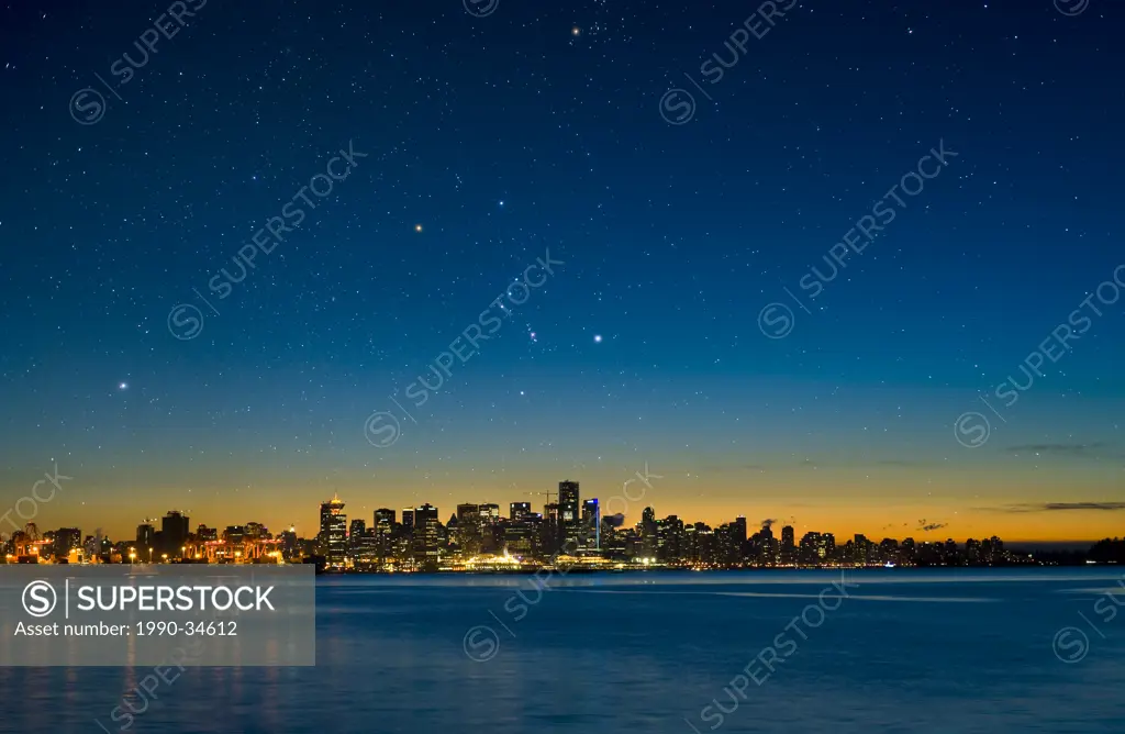 The constellation Orion setting over Vancouver skyline.