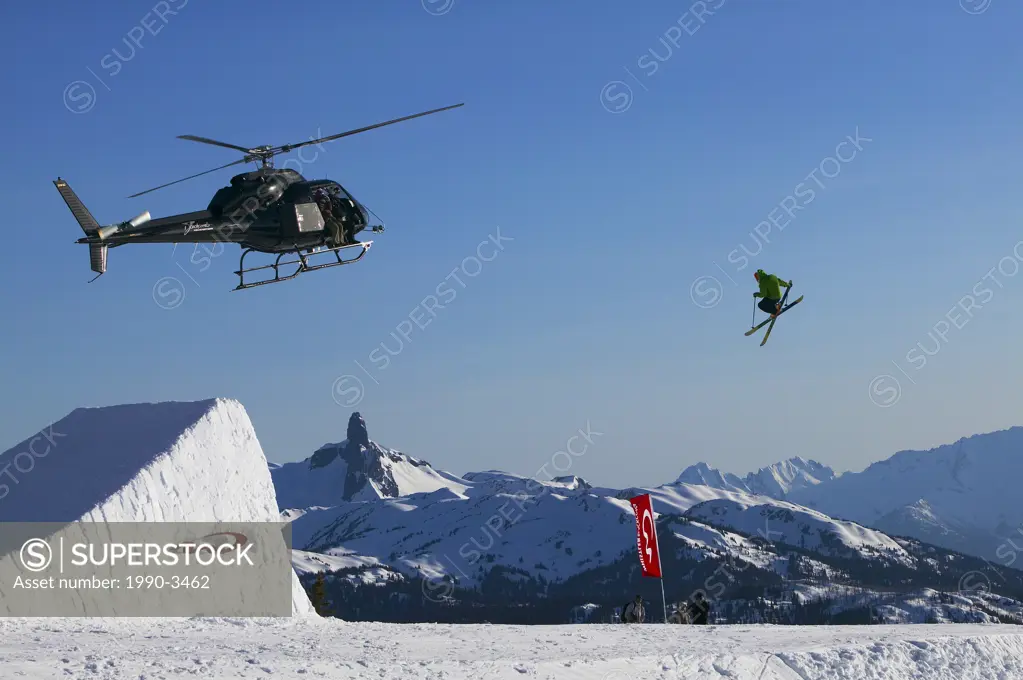 Aerial competetion on whistler mountain with black tusk and the tantalus range in the background, british columbia, Canada